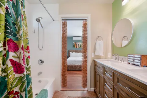 a bathroom with a sink vanity mirror and toilet