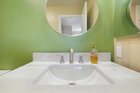 a view of kitchen with stainless steel appliances granite countertop cabinets and wooden floor