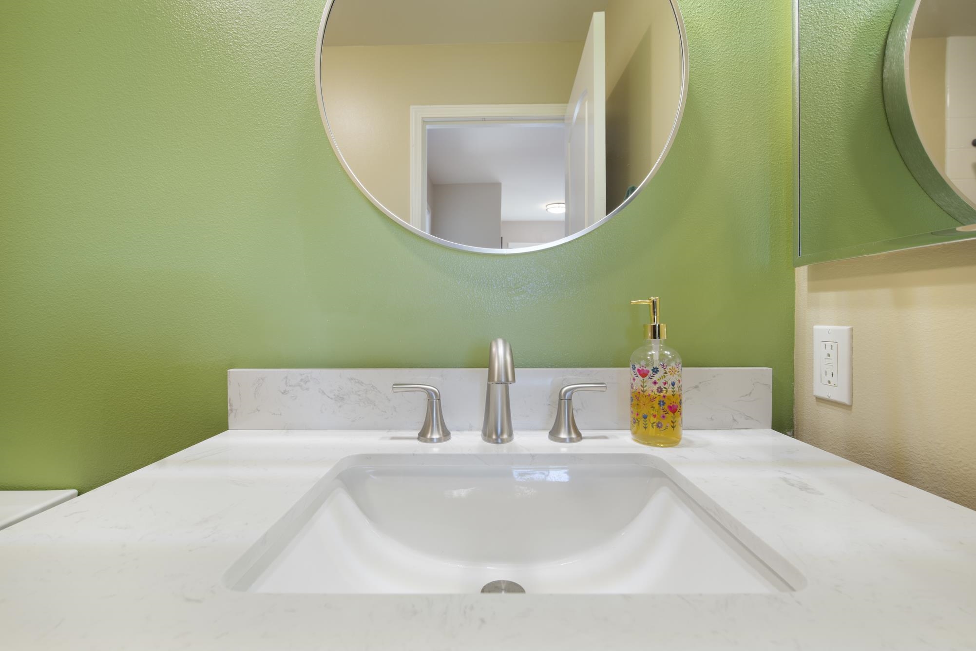 223 Lau Oliwa Loop, Unit 38 Wailuku, HI 96793 - Photo 30 of 50 a bathroom with a sink and a mirror