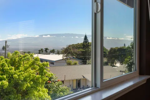 an aerial view of a house with garden space and street view