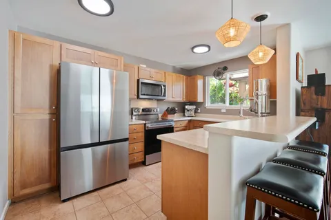 a kitchen with stainless steel appliances granite countertop a refrigerator a stove a sink and a refrigerator