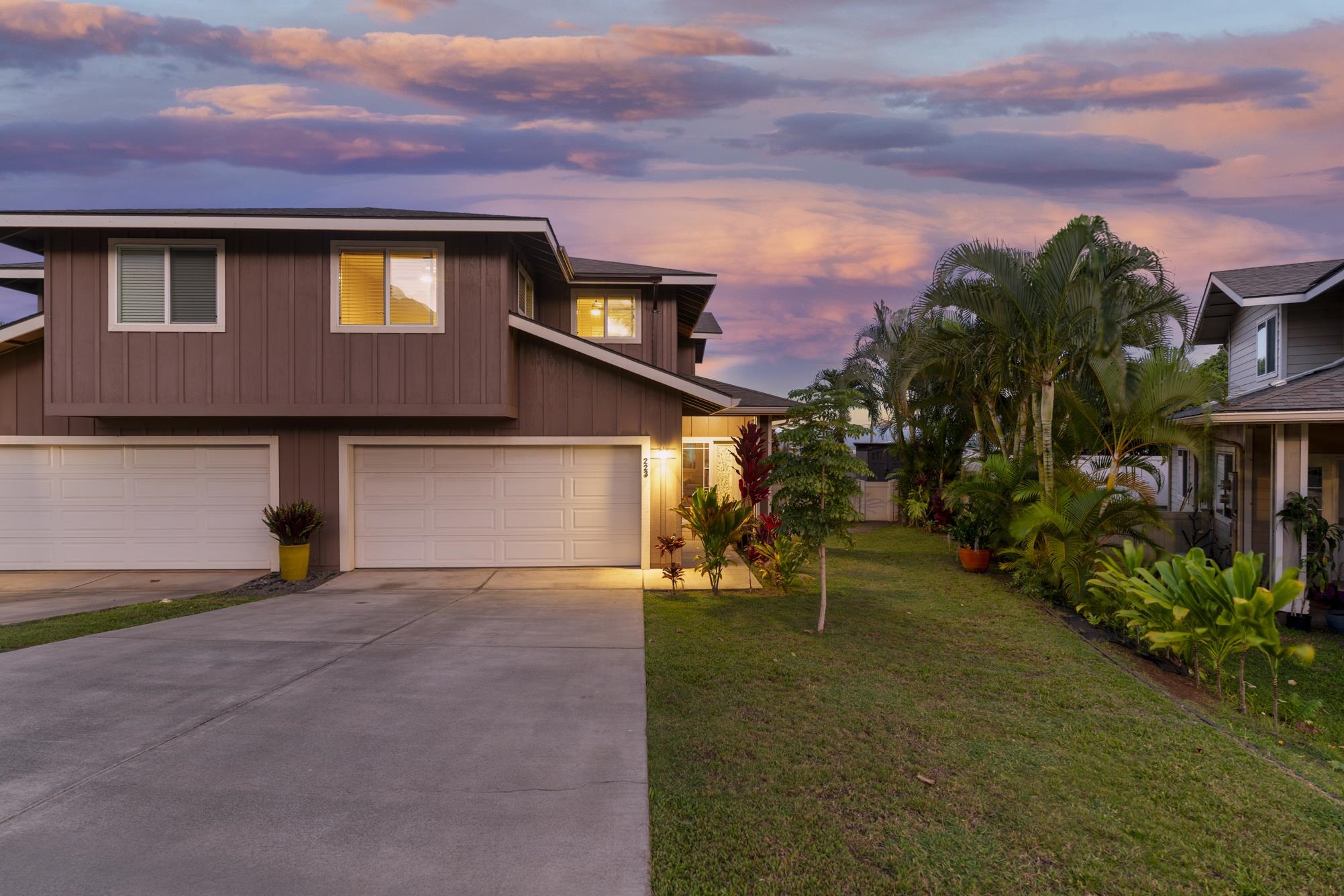 223 Lau Oliwa Loop, Unit 38 Wailuku, HI 96793 - Photo 47 of 50 a front view of a house with a yard and garage