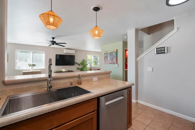 a kitchen with stainless steel appliances granite countertop a sink and a microwave