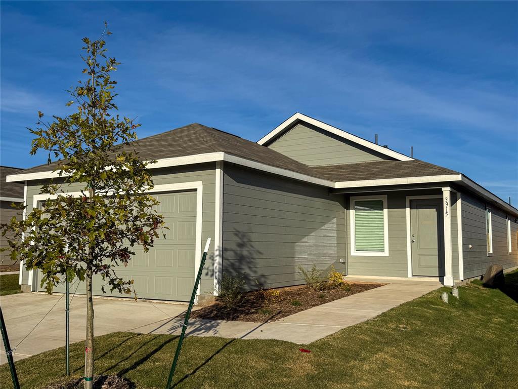 3915 Selawik Street Sherman, TX 75090 - Photo 1 of 19 a front view of a house with a yard