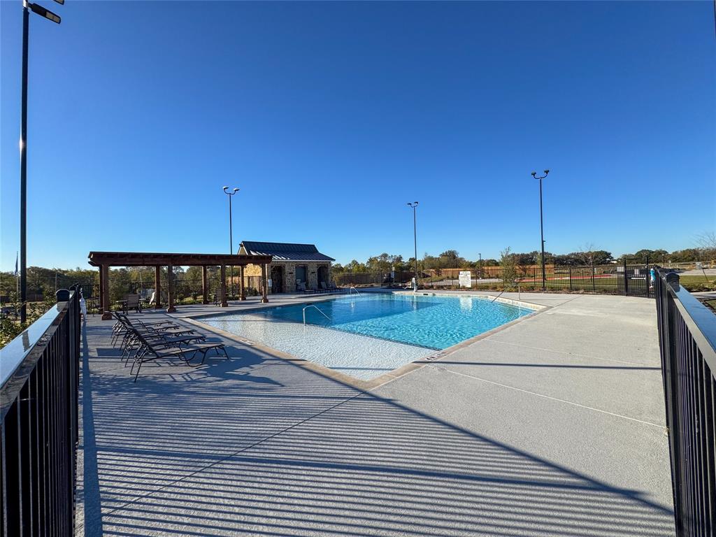 3915 Selawik Street Sherman, TX 75090 - Photo 19 of 19 a view of a swimming pool with a yard