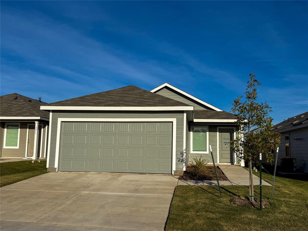 3915 Selawik Street Sherman, TX 75090 - Photo 2 of 19 a front view of a house with a yard and garage