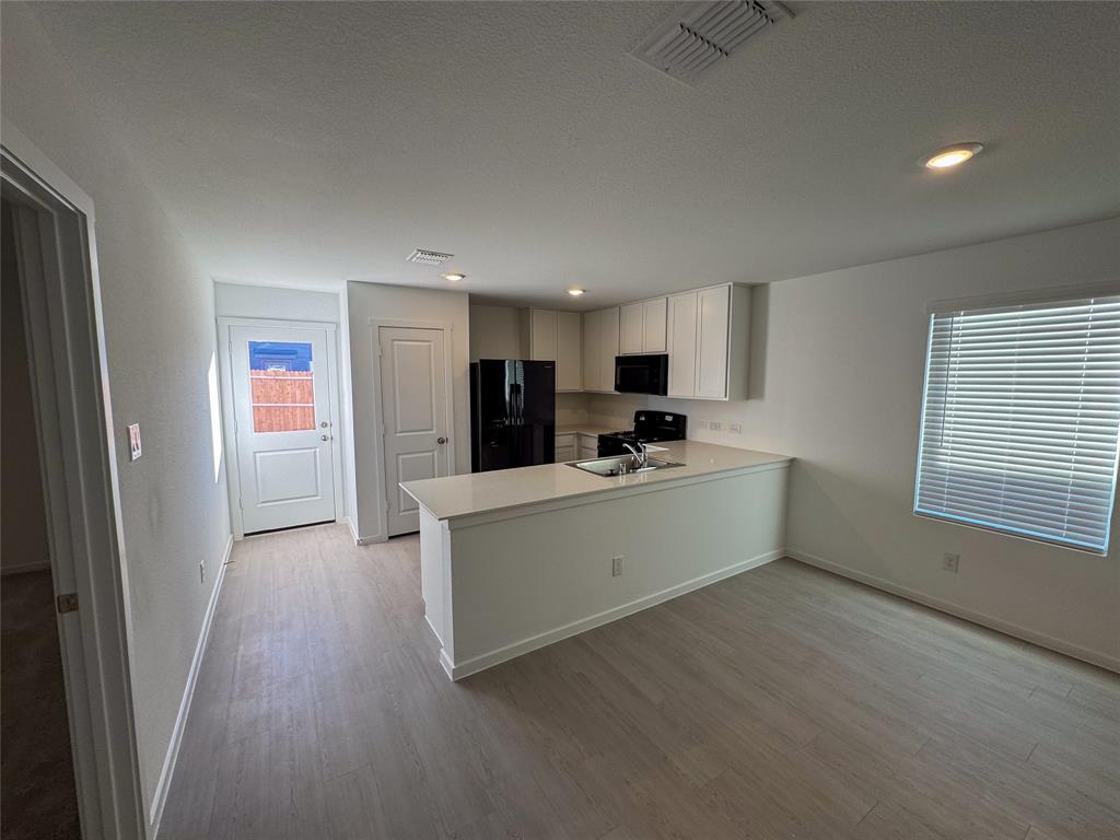 3915 Selawik Street Sherman, TX 75090 - Photo 5 of 19 a view of a kitchen with refrigerator and windows