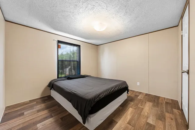 a bedroom with a bed and window