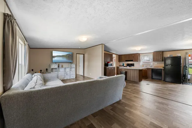 a living room with furniture and kitchen view