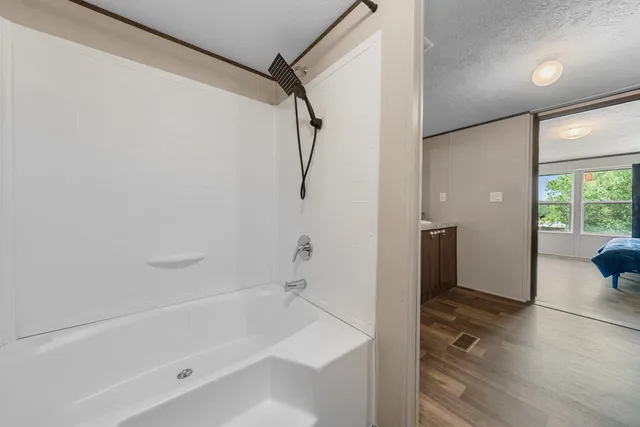 a bathroom with a bathtub and a shower