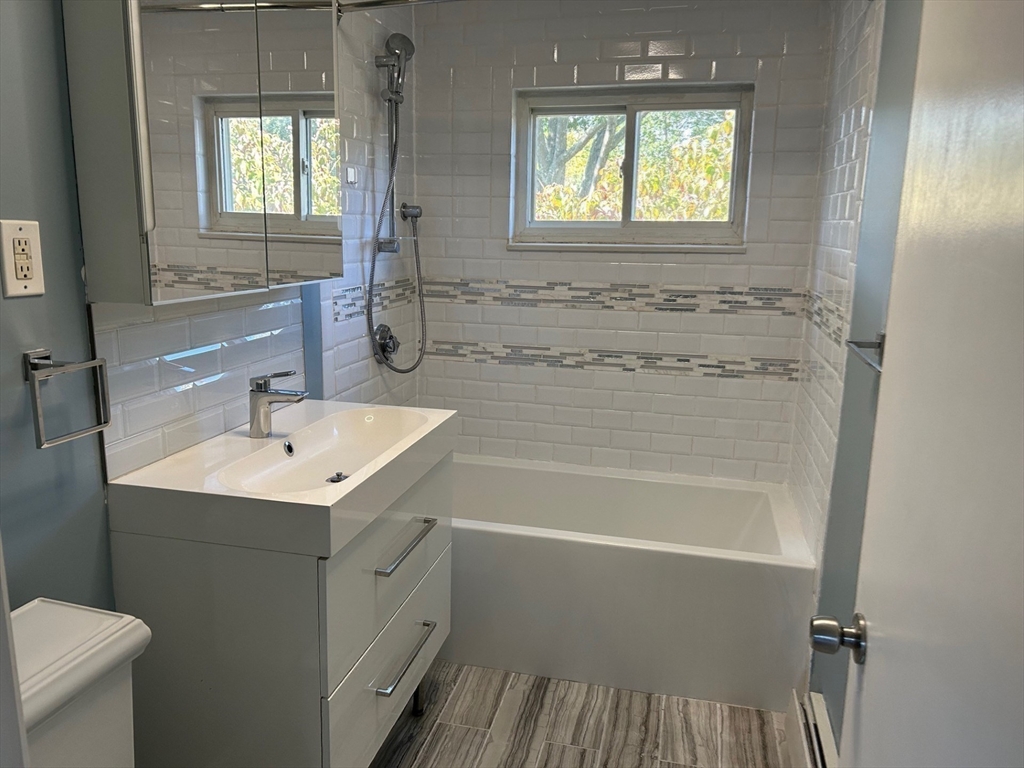 37 Will Drive, Unit 12 Canton, MA 02021 - Photo 15 of 20 a bathroom with a sink a toilet and shower