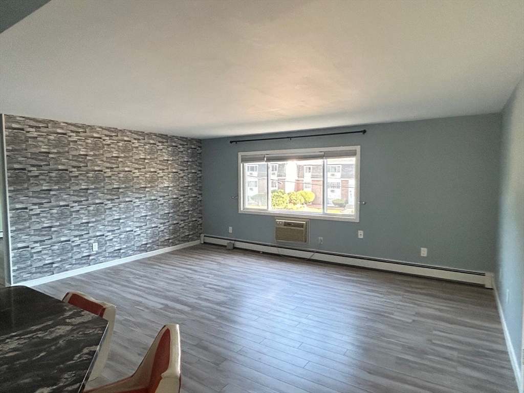 37 Will Drive, Unit 12 Canton, MA 02021 - Photo 7 of 20 a view of an empty room with wooden floor and a window
