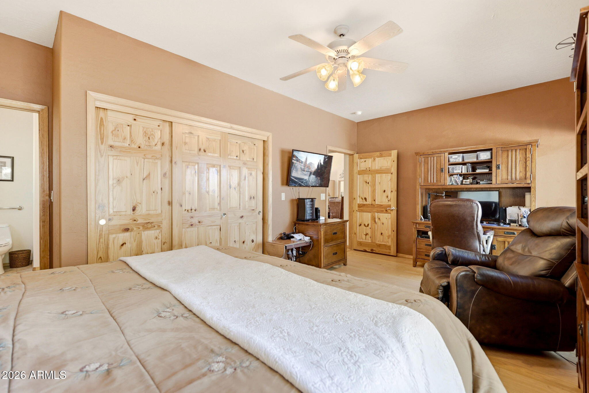 826 Pine Creek Circle Lakeside, AZ 85929 - Photo 27 of 63 a bedroom with a bed gym equipment and a chandelier