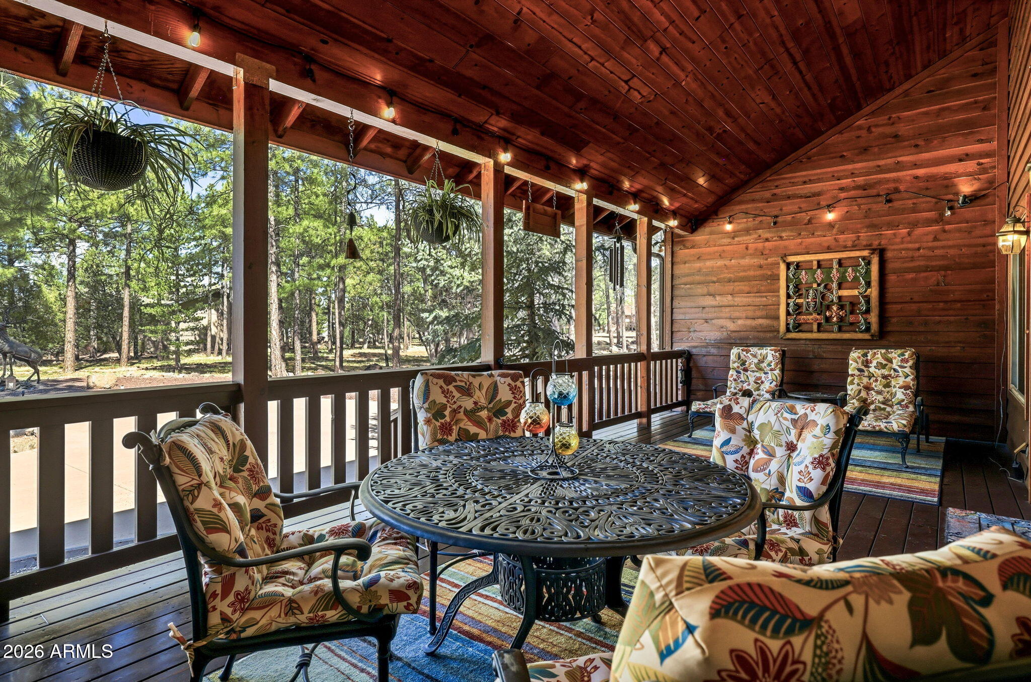 826 Pine Creek Circle Lakeside, AZ 85929 - Photo 35 of 63 a view of a patio with table and chairs with wooden floor and fence