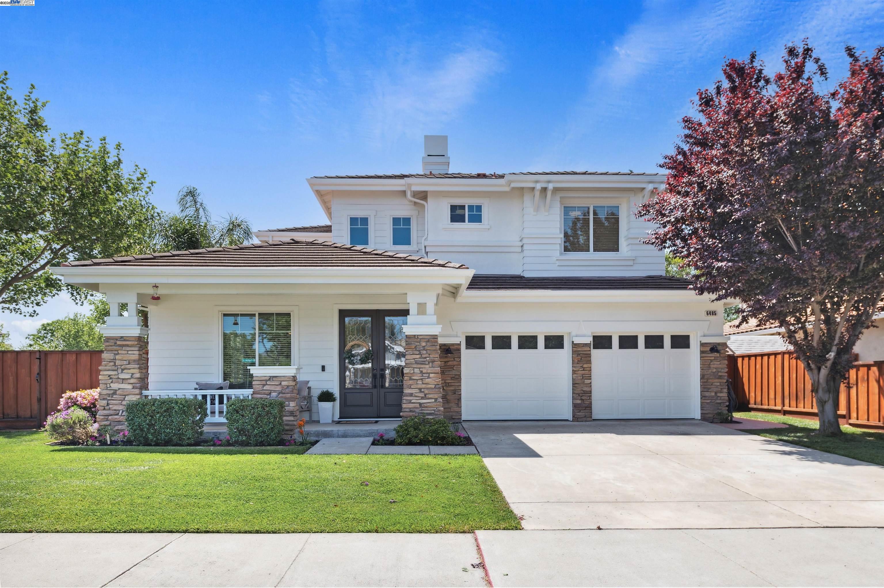 a front view of a house with a garden