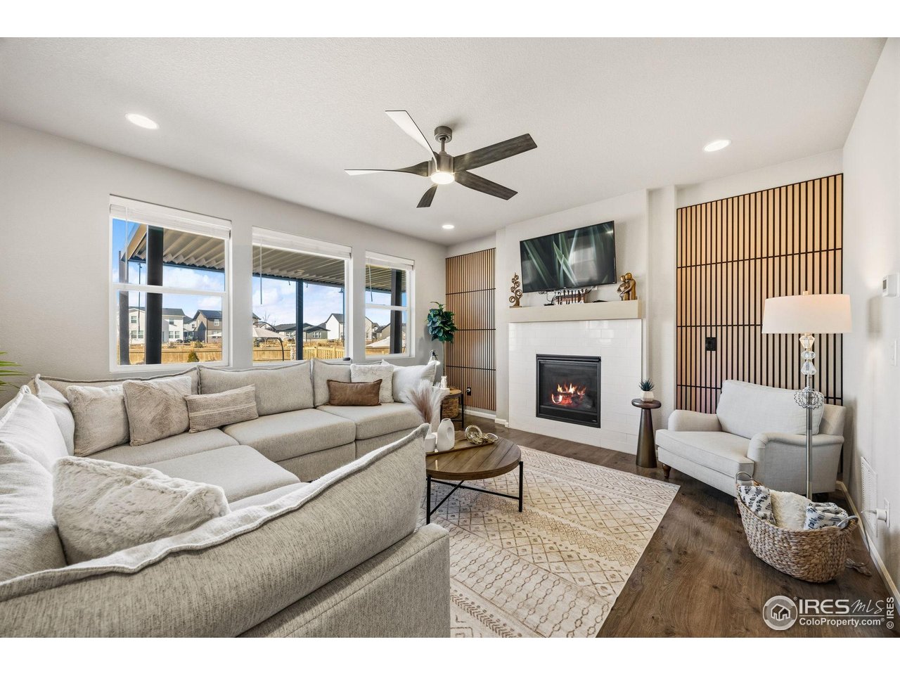5247 Alberta Falls Street Timnath, CO 80547 - Photo 11 of 43 Living room with large windows and natural light