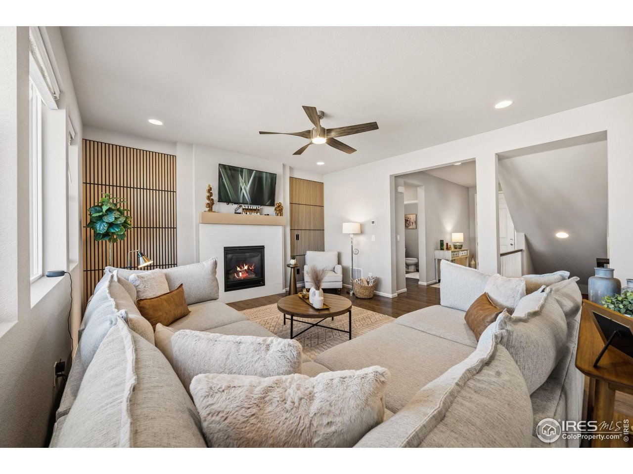5247 Alberta Falls Street Timnath, CO 80547 - Photo 12 of 43 Living room with gas fireplace and accent wall