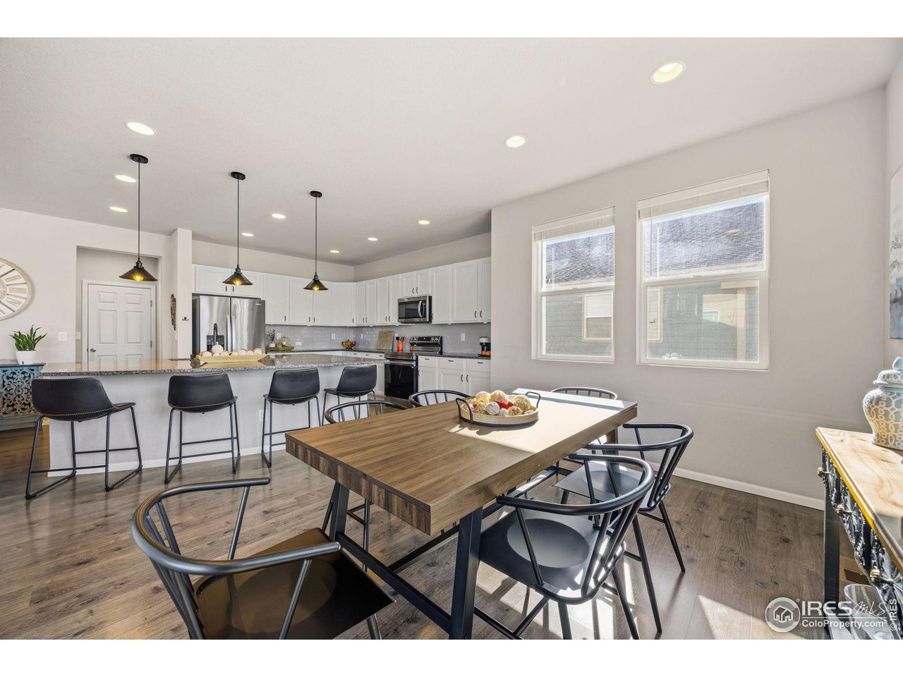 5247 Alberta Falls Street Timnath, CO 80547 - Photo 43 of 43 Kitchen and dining area showcasing an open floor plan and natural light