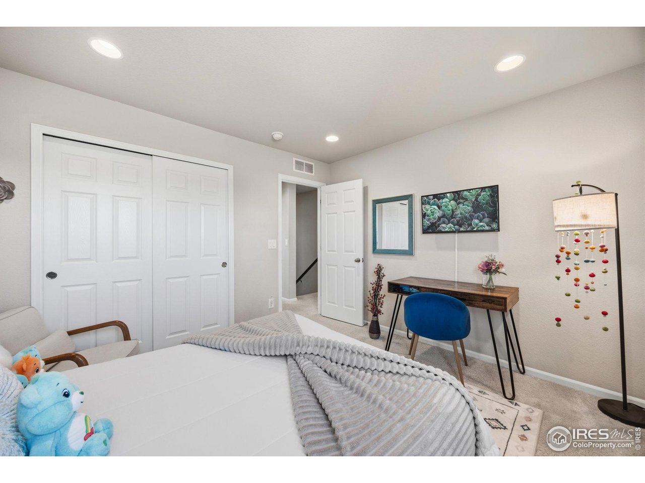 5247 Alberta Falls Street Timnath, CO 80547 - Photo 24 of 43 Light-filled secondary bedroom with neutral palette