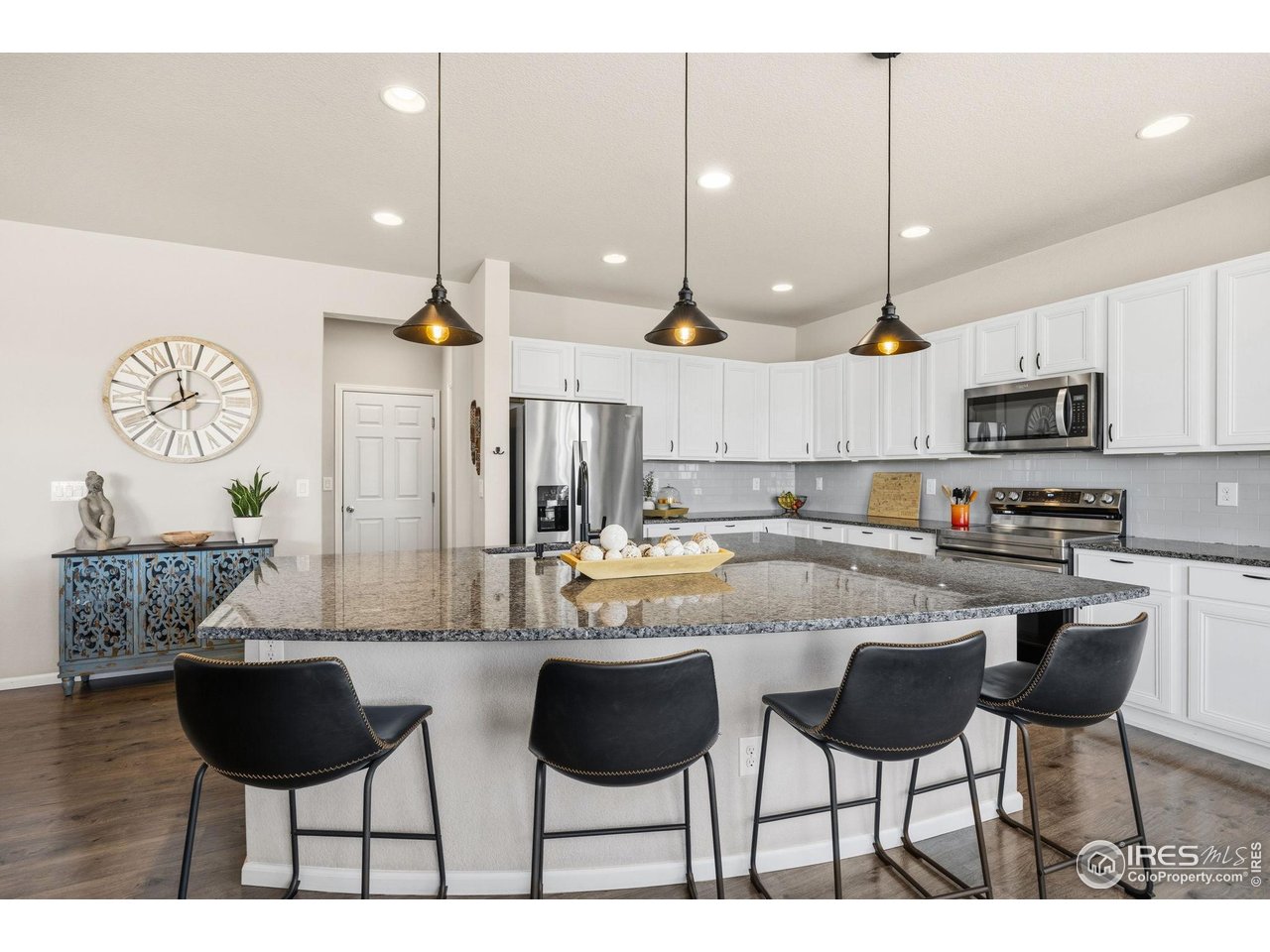 5247 Alberta Falls Street Timnath, CO 80547 - Photo 4 of 43 Spacious kitchen with large center island and pendant lighting