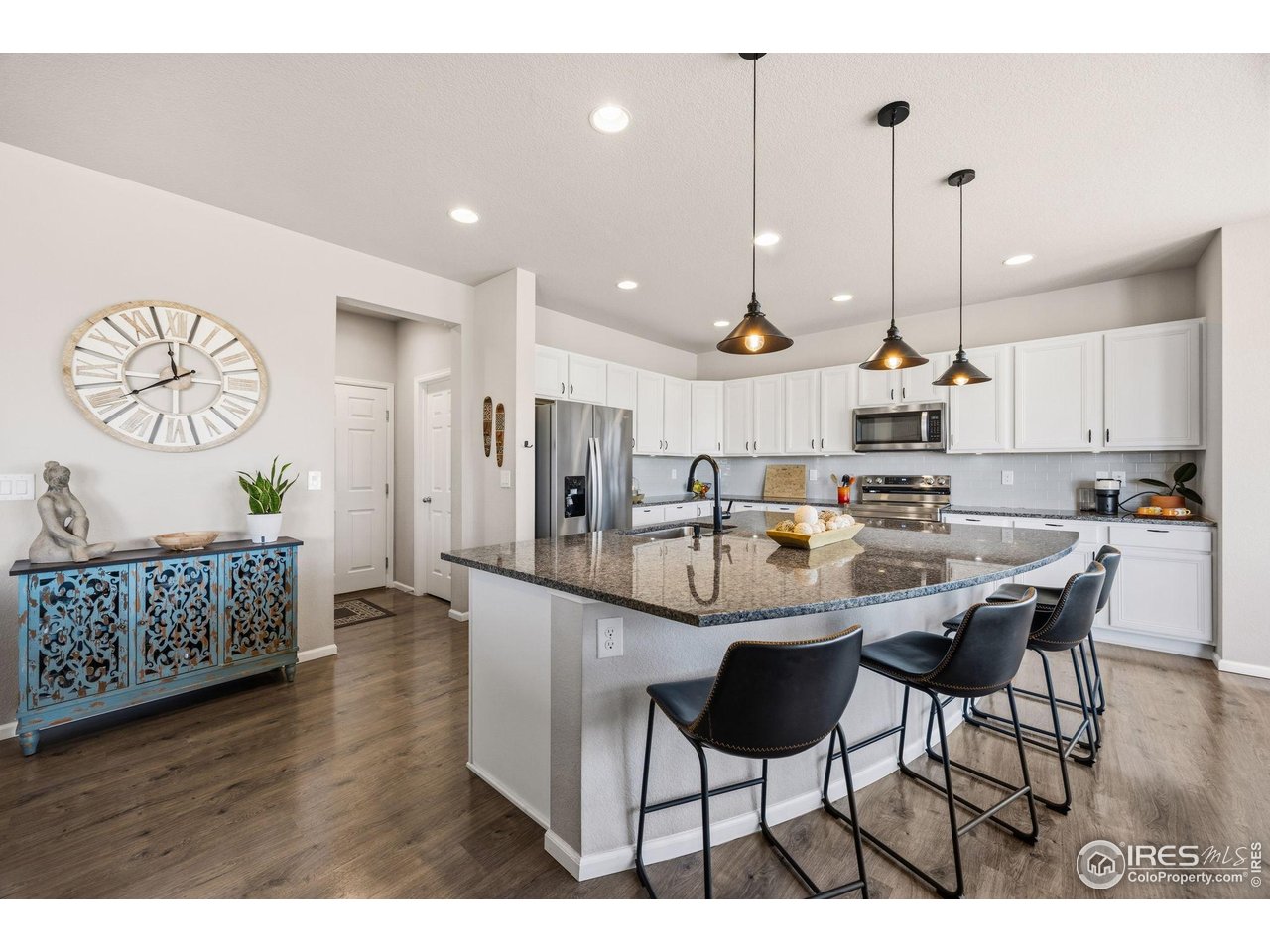 5247 Alberta Falls Street Timnath, CO 80547 - Photo 6 of 43 Kitchen island with seating and granite countertops