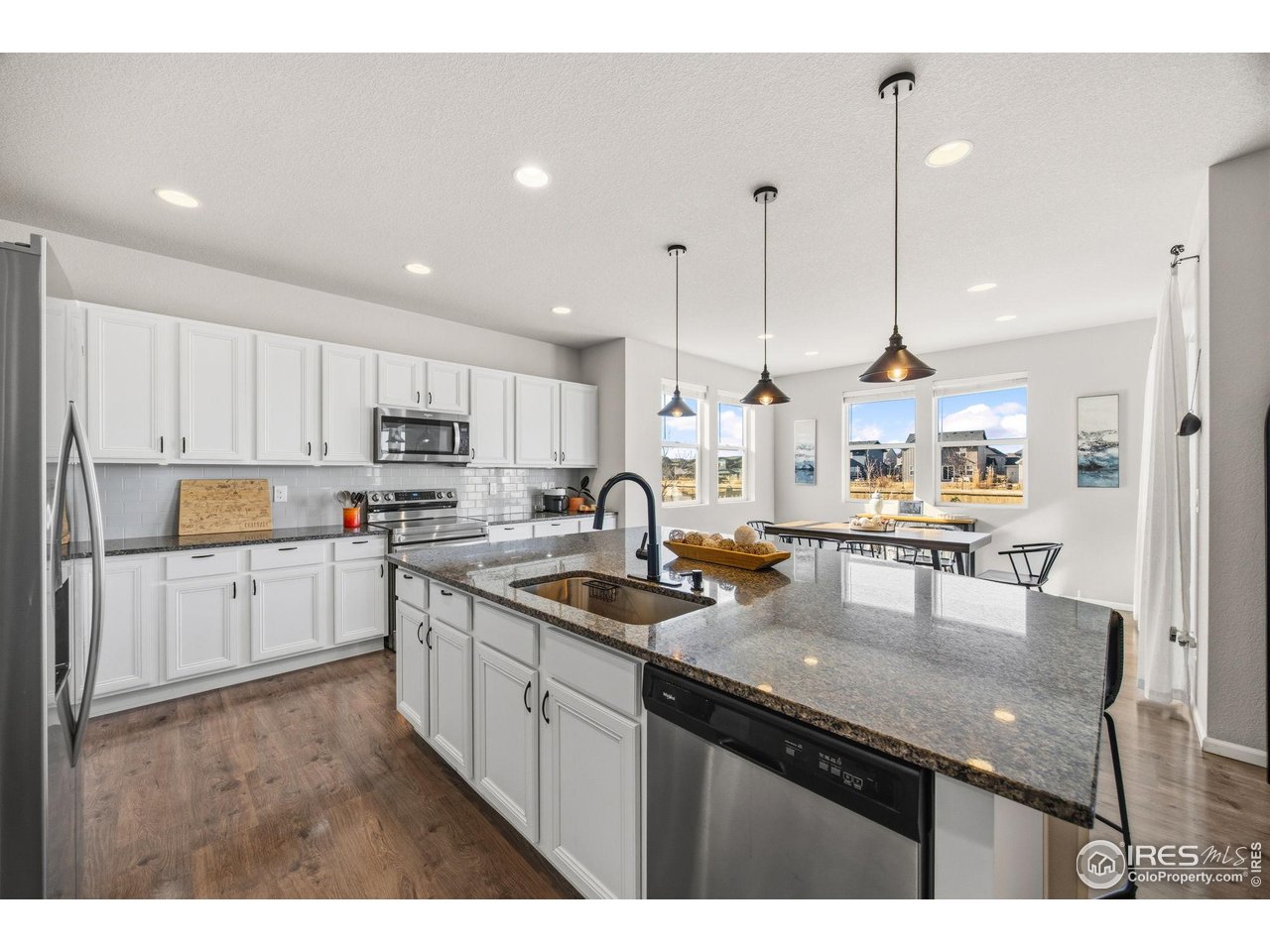 5247 Alberta Falls Street Timnath, CO 80547 - Photo 9 of 43 Kitchen with island sink, stainless appliances, and ample counter space