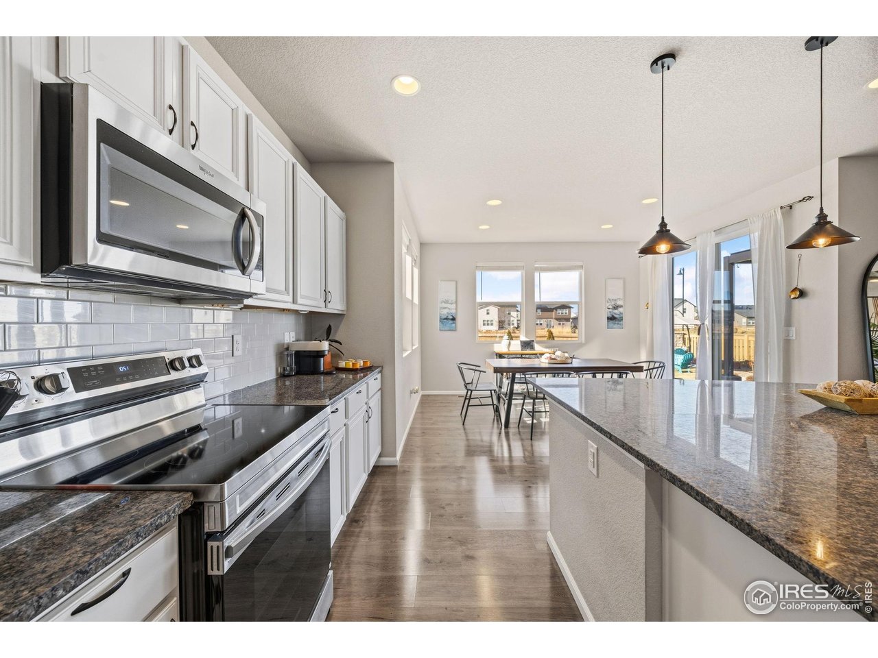 5247 Alberta Falls Street Timnath, CO 80547 - Photo 10 of 43 Kitchen and dining area with abundant natural light