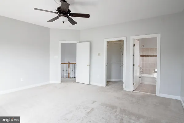 a view of empty room with ceiling fan