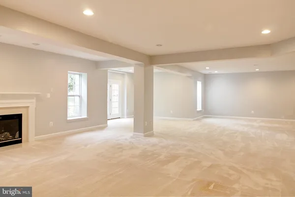 a view of an empty room with a fireplace