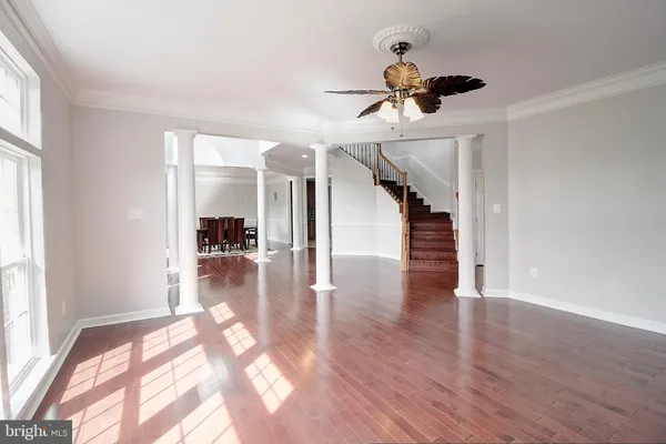 a view of interior space with wooden floor and window