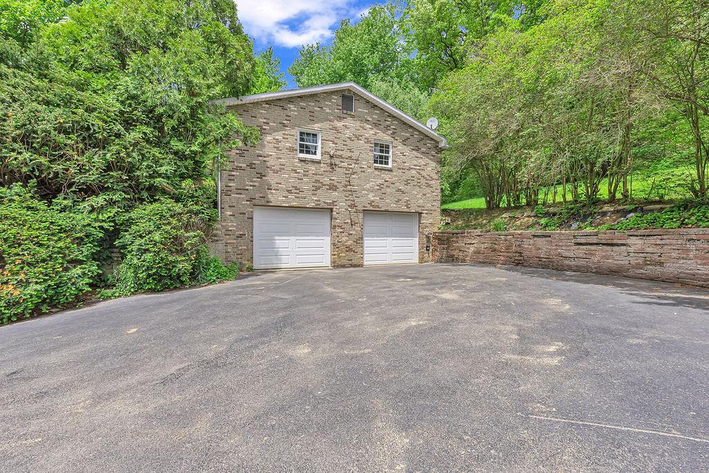 171 Dehaven Road Beaver Falls, PA 15010 - Photo 3 of 35 a front view of a house with a yard and garage