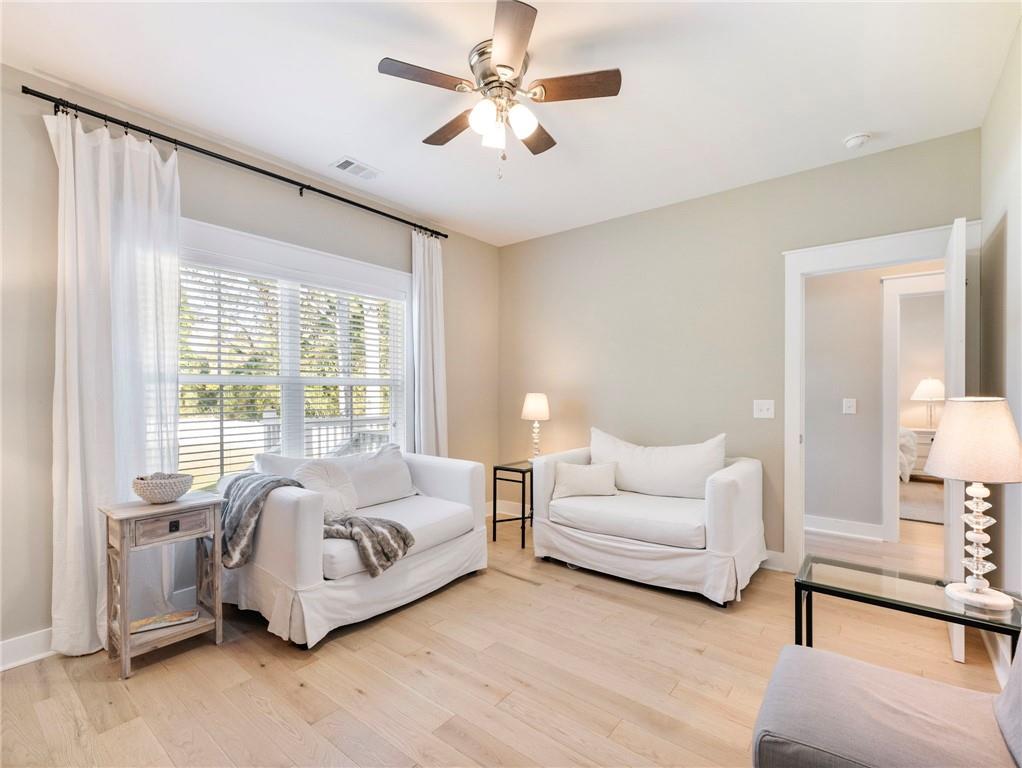232 Campbell Street Cleveland, GA 30528 - Photo 20 of 37 a spacious bedroom with a bed a couch and a chandelier