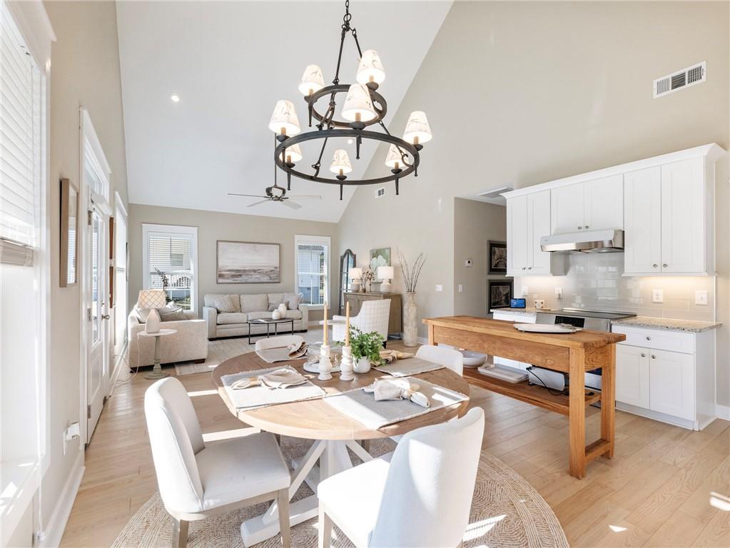 232 Campbell Street Cleveland, GA 30528 - Photo 8 of 37 a dining room with stainless steel appliances kitchen island granite countertop a table and chairs in it