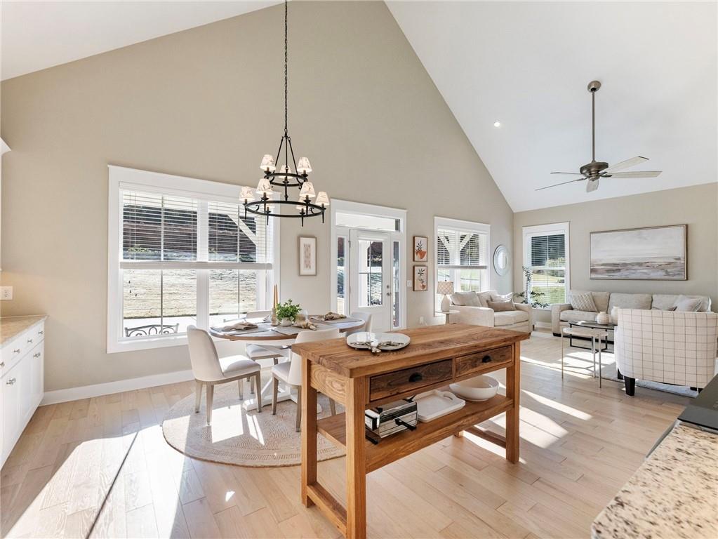 232 Campbell Street Cleveland, GA 30528 - Photo 9 of 37 a dining room with wooden floor a chandelier a wooden table and chairs