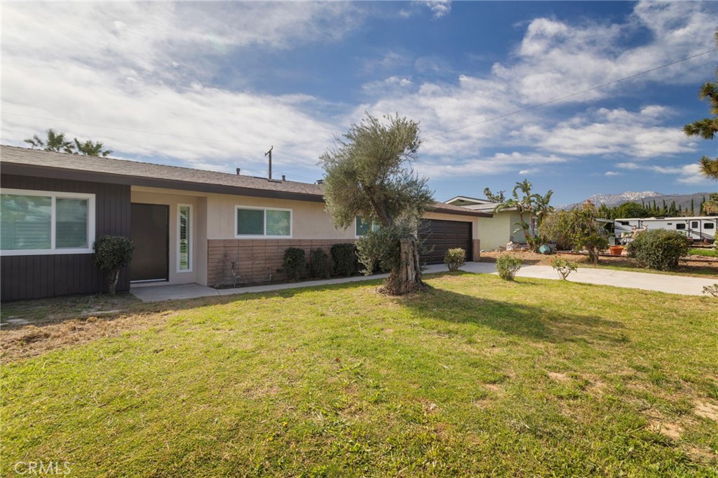 5874 Olive Avenue Rialto, CA 92377 - Photo 19 of 50 a view of house with yard and swimming pool
