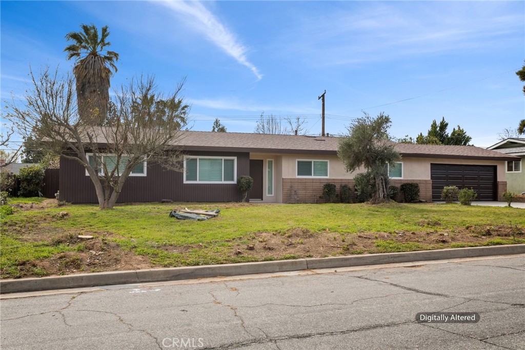 5874 Olive Avenue Rialto, CA 92377 - Photo 21 of 50 a front view of a house with a garden