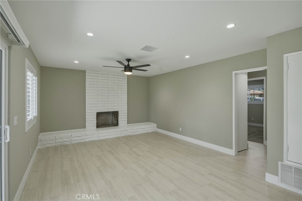 5874 Olive Avenue Rialto, CA 92377 - Photo 23 of 50 an empty room with wooden floor and fireplace
