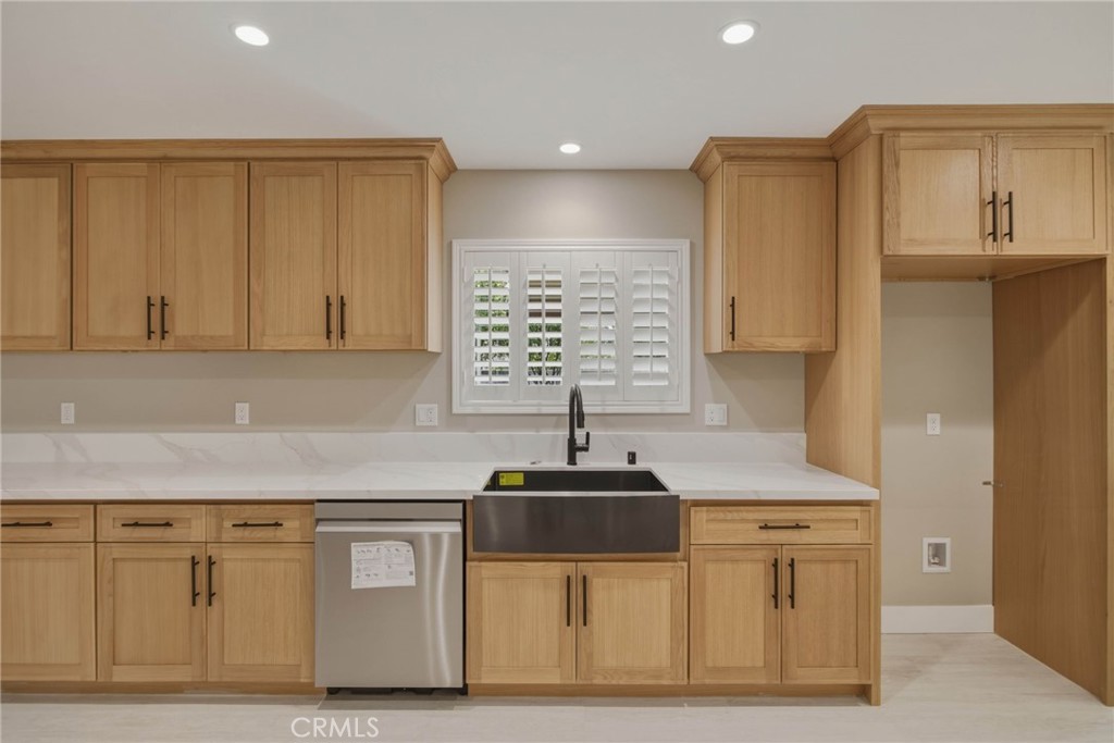 5874 Olive Avenue Rialto, CA 92377 - Photo 25 of 50 a kitchen with stainless steel appliances granite countertop a sink and dishwasher a stove top oven with wooden floor