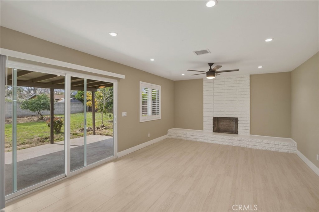 5874 Olive Avenue Rialto, CA 92377 - Photo 3 of 50 a view of an empty room with a fireplace and a window