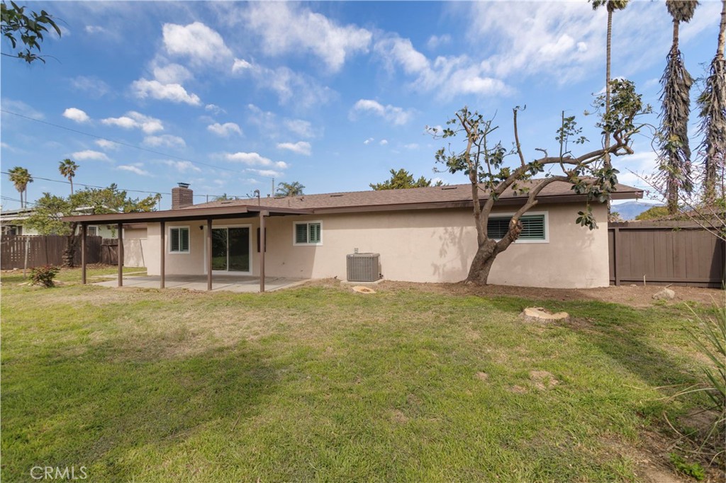 5874 Olive Avenue Rialto, CA 92377 - Photo 39 of 50 a view of a yard in front of a house with a large tree