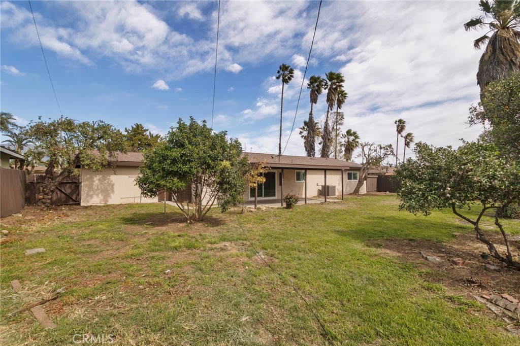 5874 Olive Avenue Rialto, CA 92377 - Photo 40 of 50 a front view of a house with a yard and garage