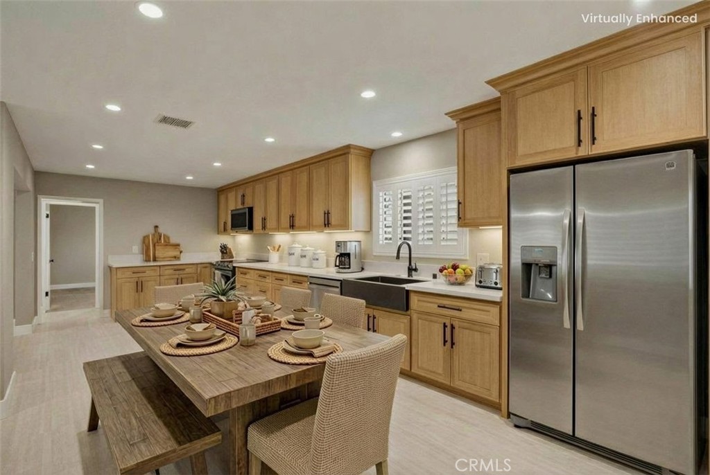 5874 Olive Avenue Rialto, CA 92377 - Photo 6 of 50 a kitchen with stainless steel appliances granite countertop a refrigerator a stove a sink a dining table and chairs