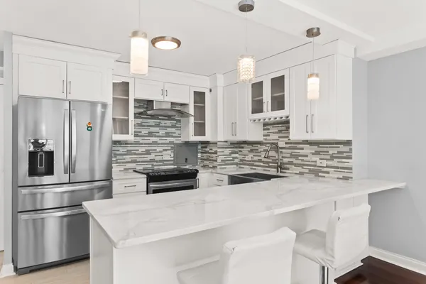 a kitchen with stainless steel appliances and white cabinets