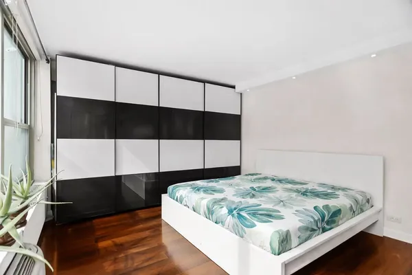 a bedroom with a bed and window