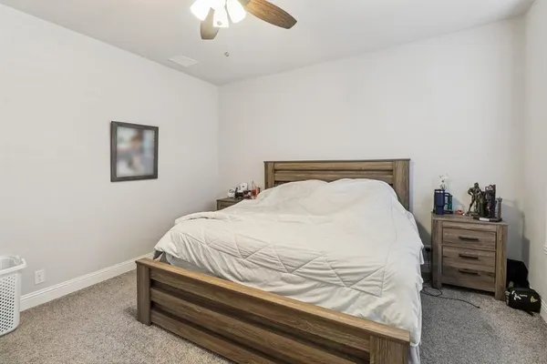 a bedroom with a bed and a dresser