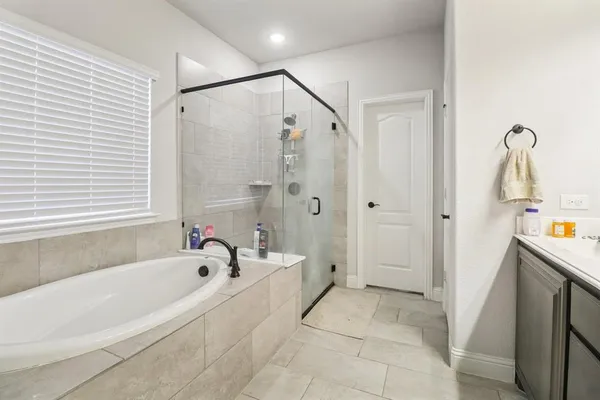 a bathroom with a bathtub and a shower