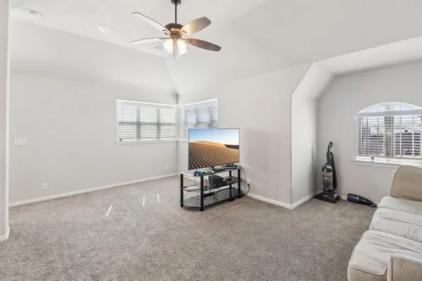 a living room with furniture and a ceiling fan