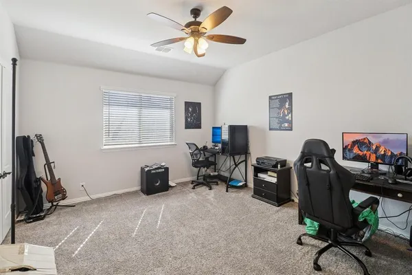 a view of a workspace with furniture and a window