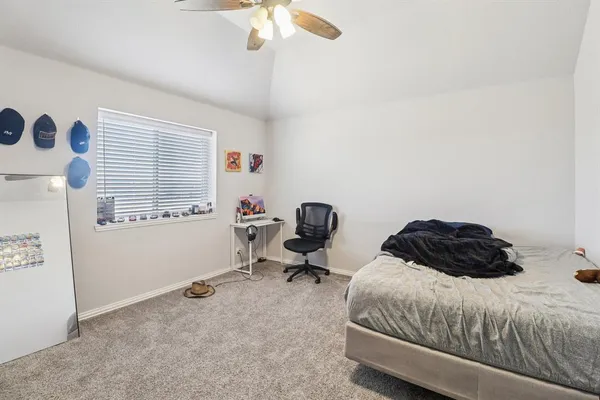 a bedroom with a bed window and a chandelier