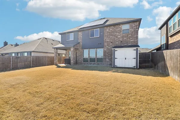 a house view with swimming pool in front of it